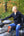 Man sitting on an ATV in a forested area wearing abode outside